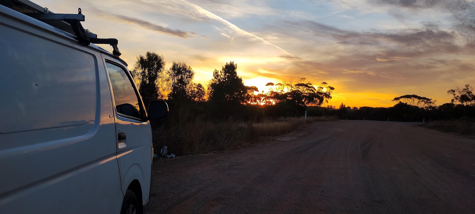 Sarah Jade's van on the road at sunset